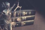 scales of justice and legal books - USPTO rules of professional conduct concept